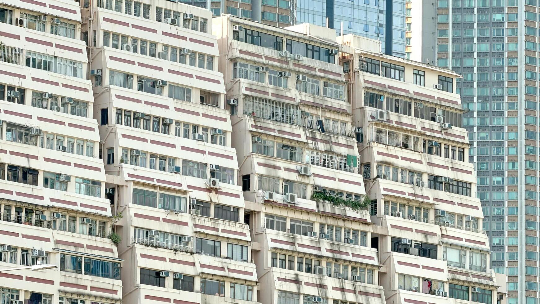 The building's facade features a distinctive pattern of windows and balconies, creating a visually appealing structure photo