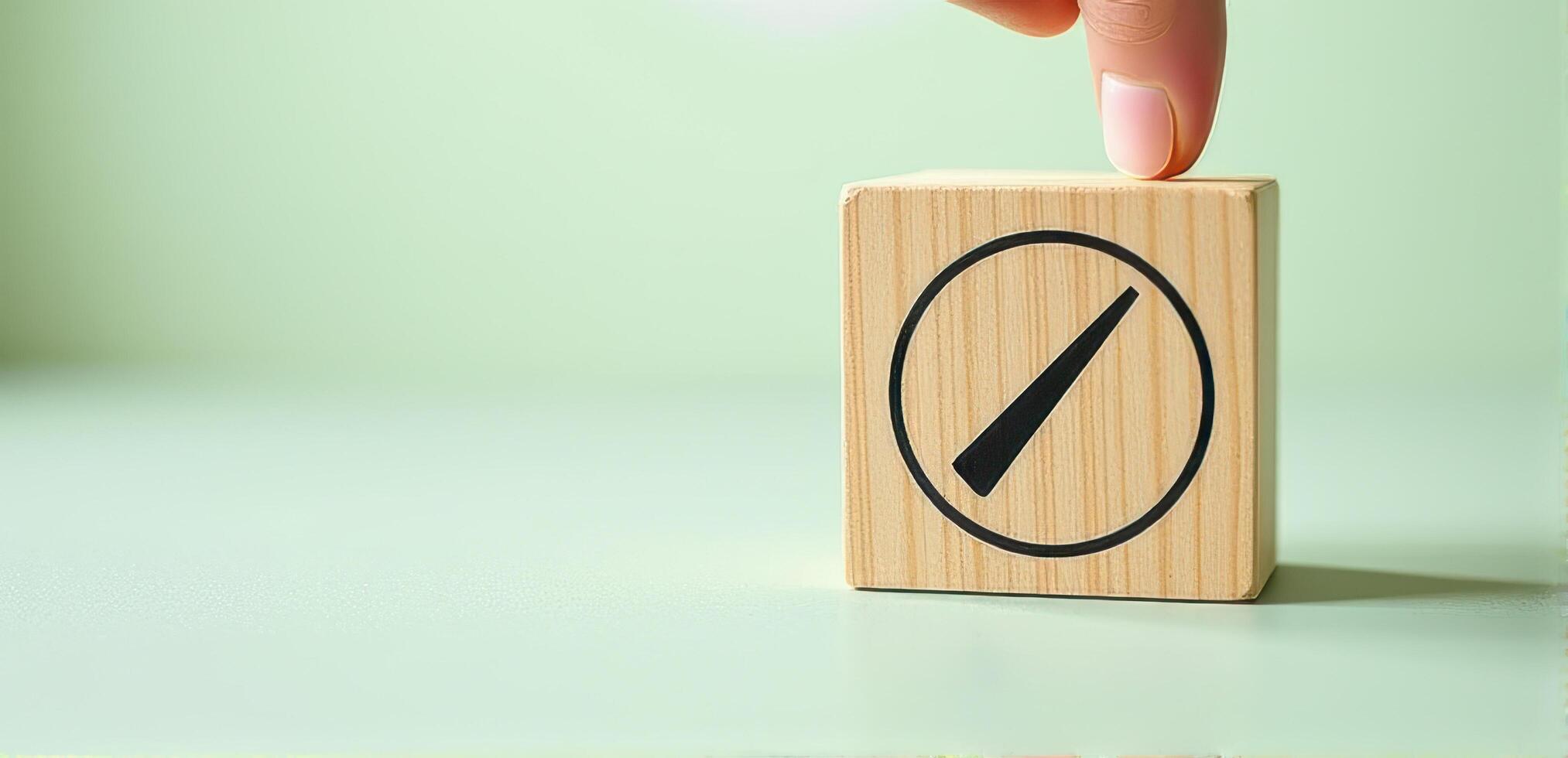 Wooden block with speedometer icon is being held by hand, symbolizing progress and efficiency. background is soft green, creating calm and focused atmosphere photo