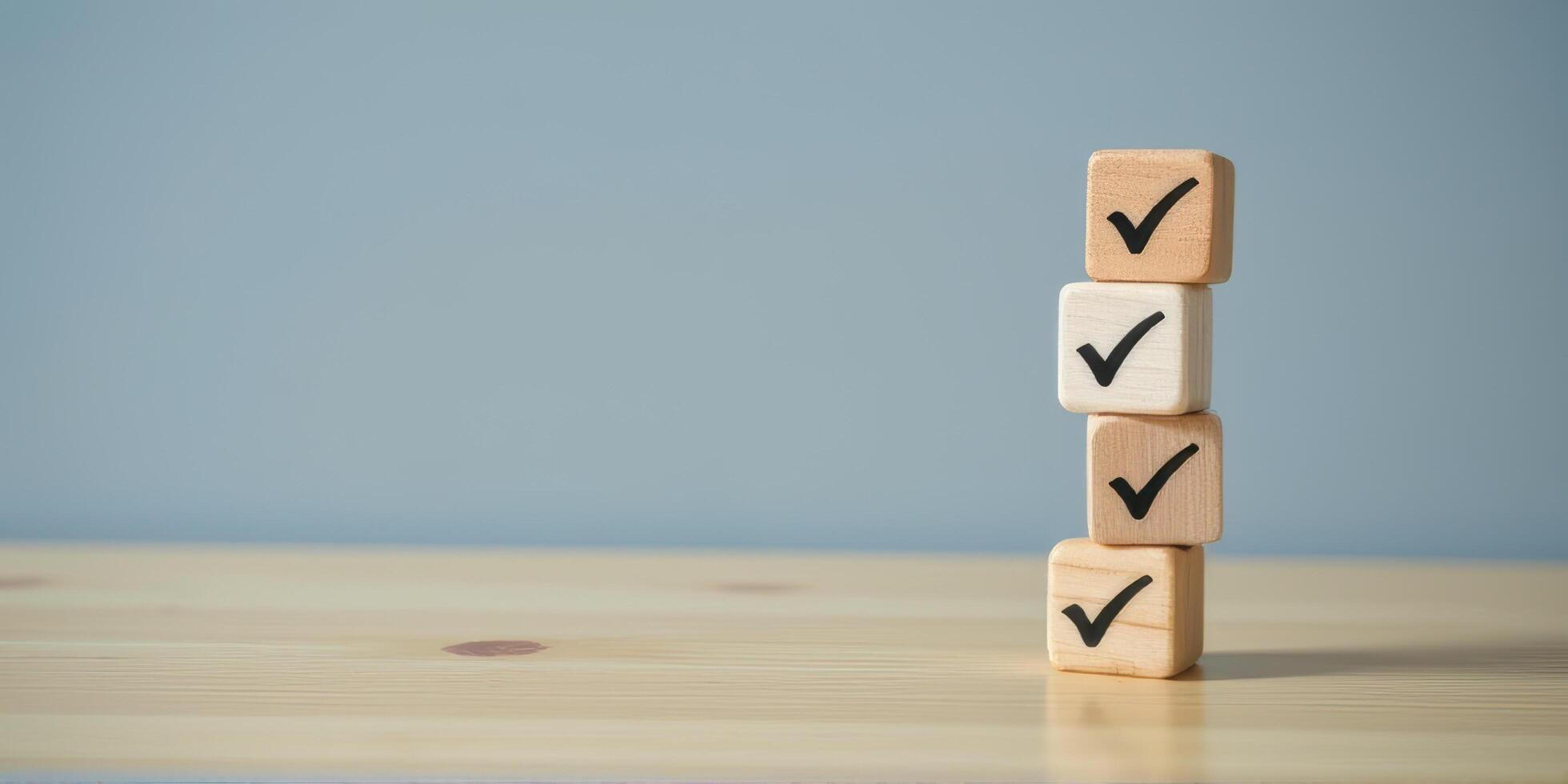 Wooden blocks with check marks stacked on wooden table, symbolizing completion and success. background is plain blue, creating calm and focused atmosphere photo