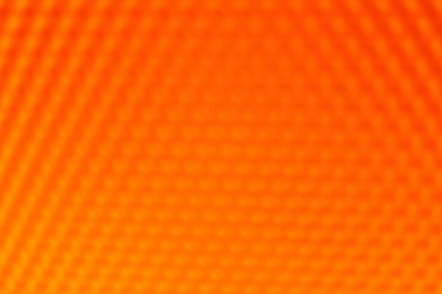 Orange yellow vibrant abstract background. The blurred geometric hexagonal pattern creates a warm, intense, and dynamic texture photo