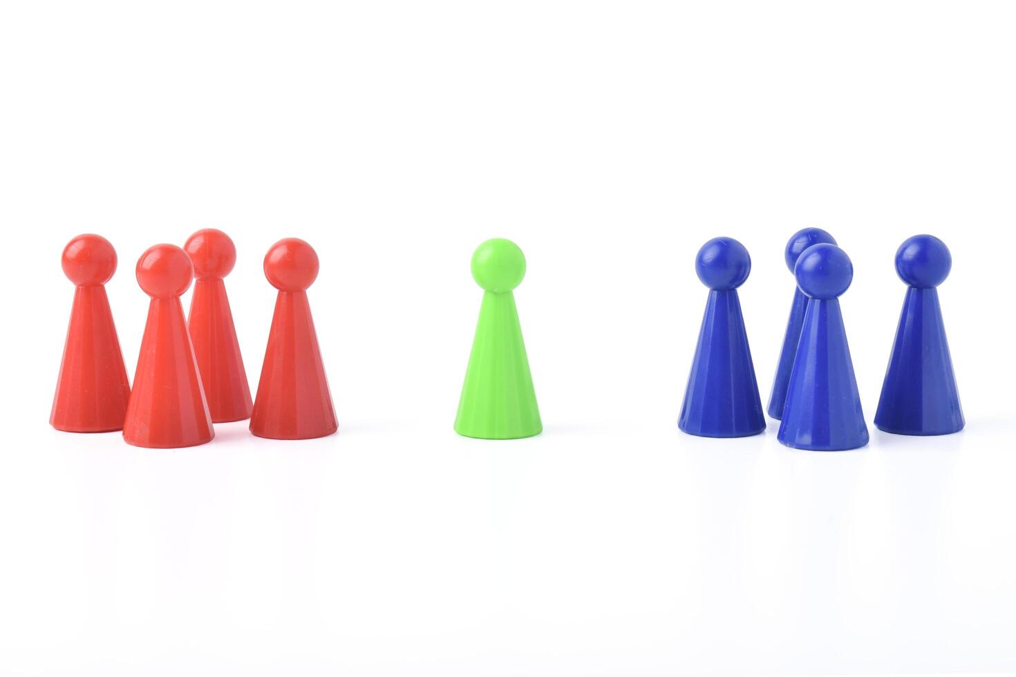 Three distinct groups of colorful cone-shaped game pieces arranged on a white background. photo
