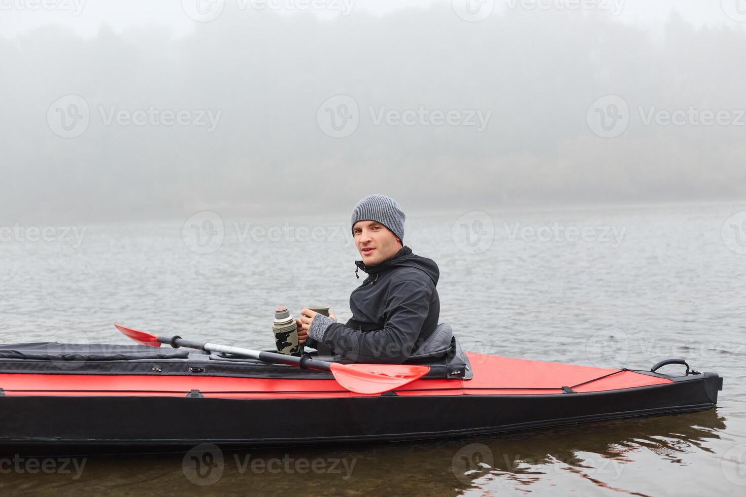 Kayaker on a foggy river photo