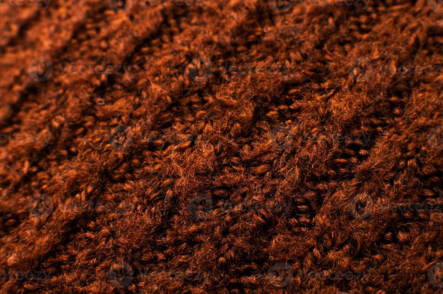 Background of knitting patterns. A close-up photo from above of the rows of a warm sweater made using the garter stitch technique and thick yarn. Fabric texture. woolen cloth