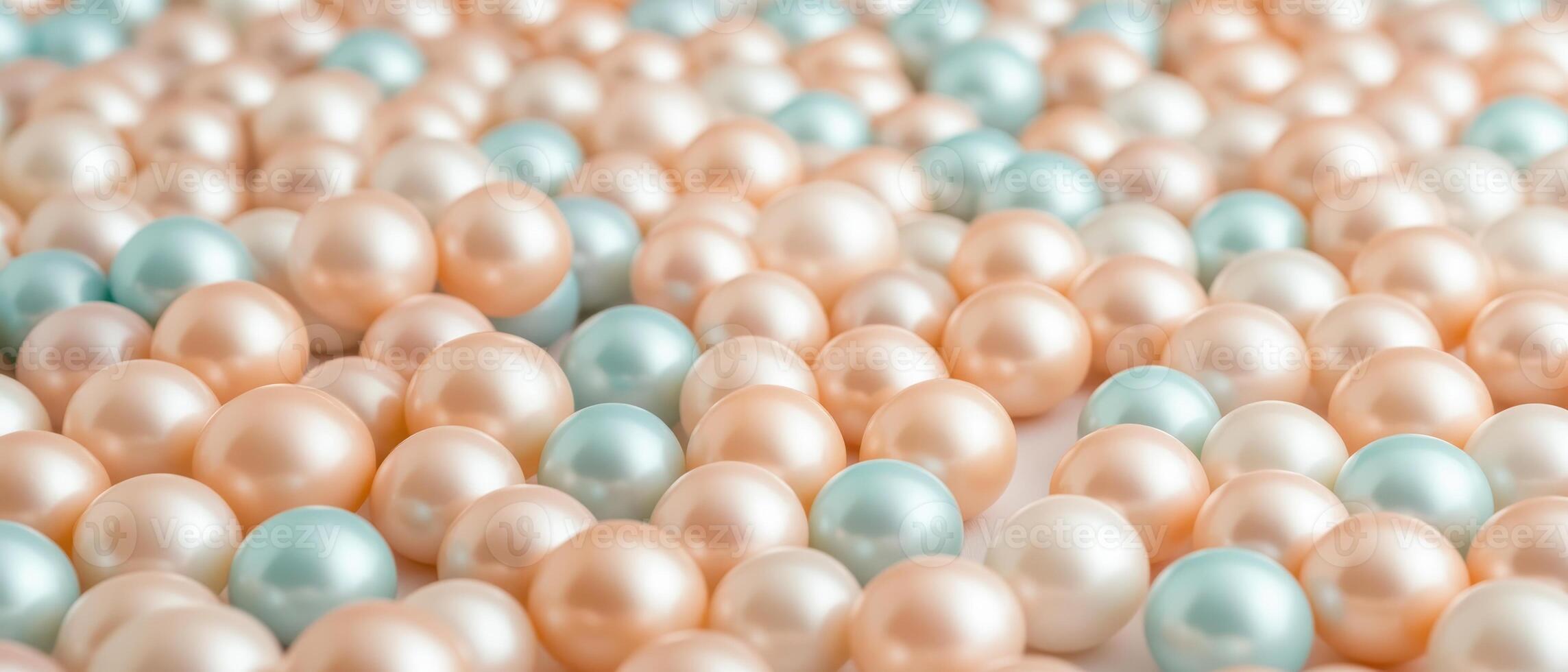 Many smooth round pearls in pale pink and soft blue colors filling the entire frame, creating a textured background of iridescent spheres. photo