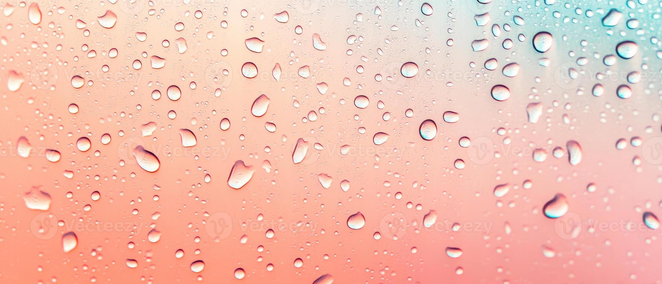 Water droplets on a soft pink and light blue gradient surface, close up view, abstract texture, liquid elements. photo