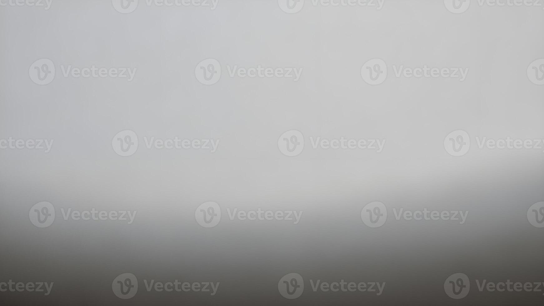 A blurred gray gradient background with a smooth transition. photo