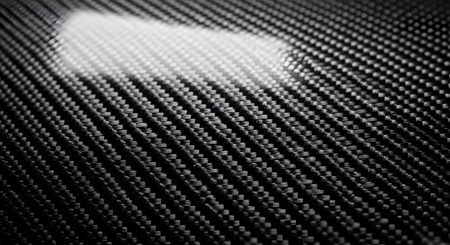 Detailed close-up of black composite material texture with an intricate woven pattern. The glossy, high-tech surface reflects light, emphasizing its modern strength and advanced design photo