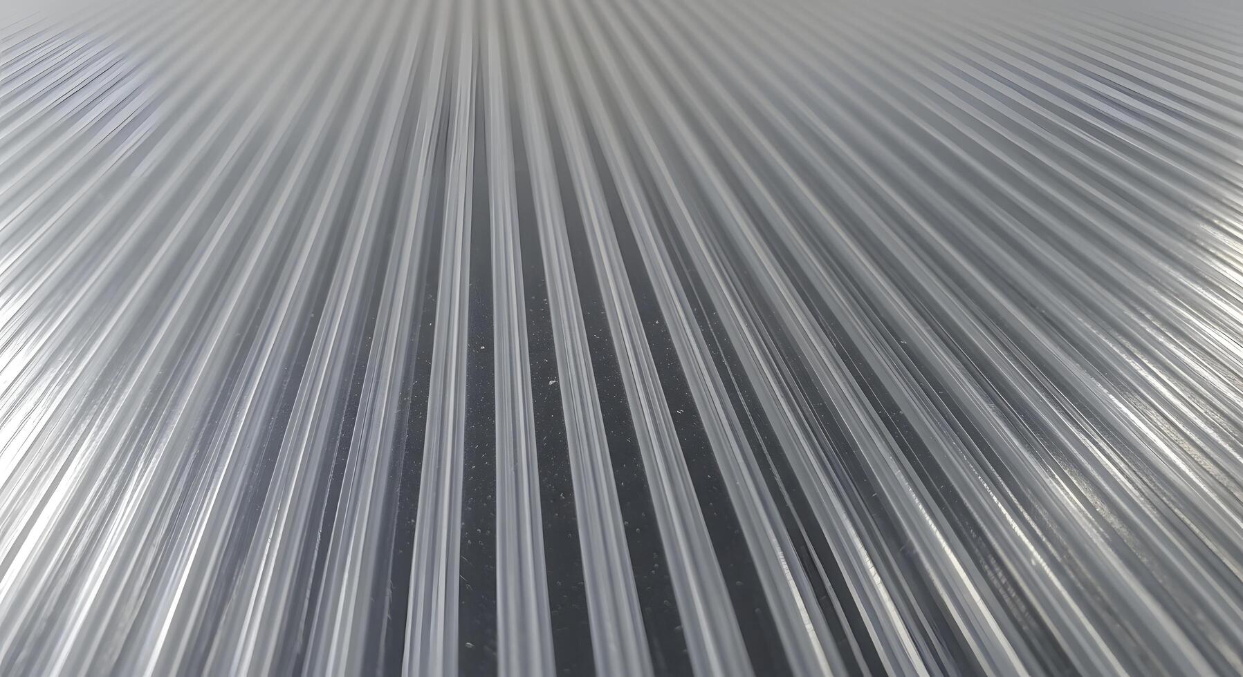 Abstract view of a clear corrugated plastic sheet, pattern of parallel lines in transparency photo