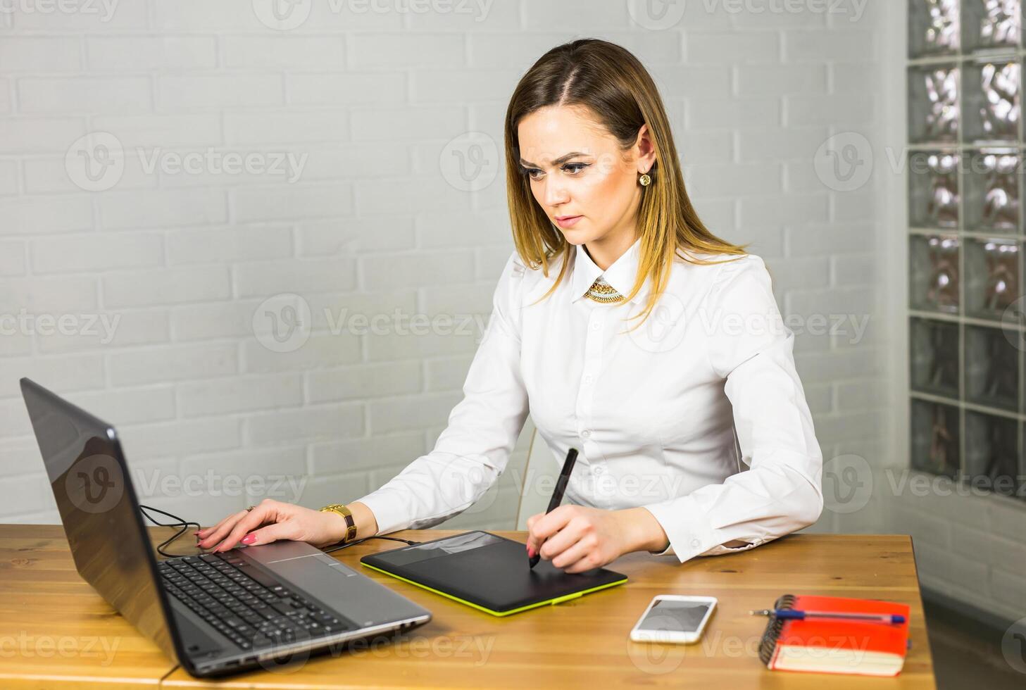 Graphic designer using digital tablet and computer in office. photo