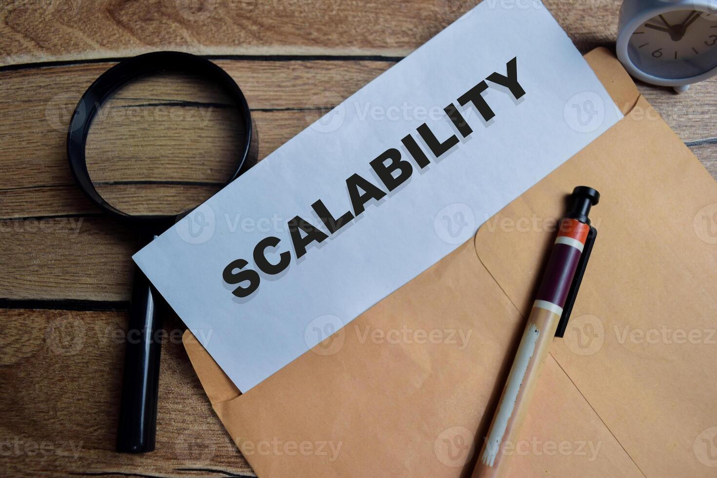 Scalability text on document above brown envelope. photo