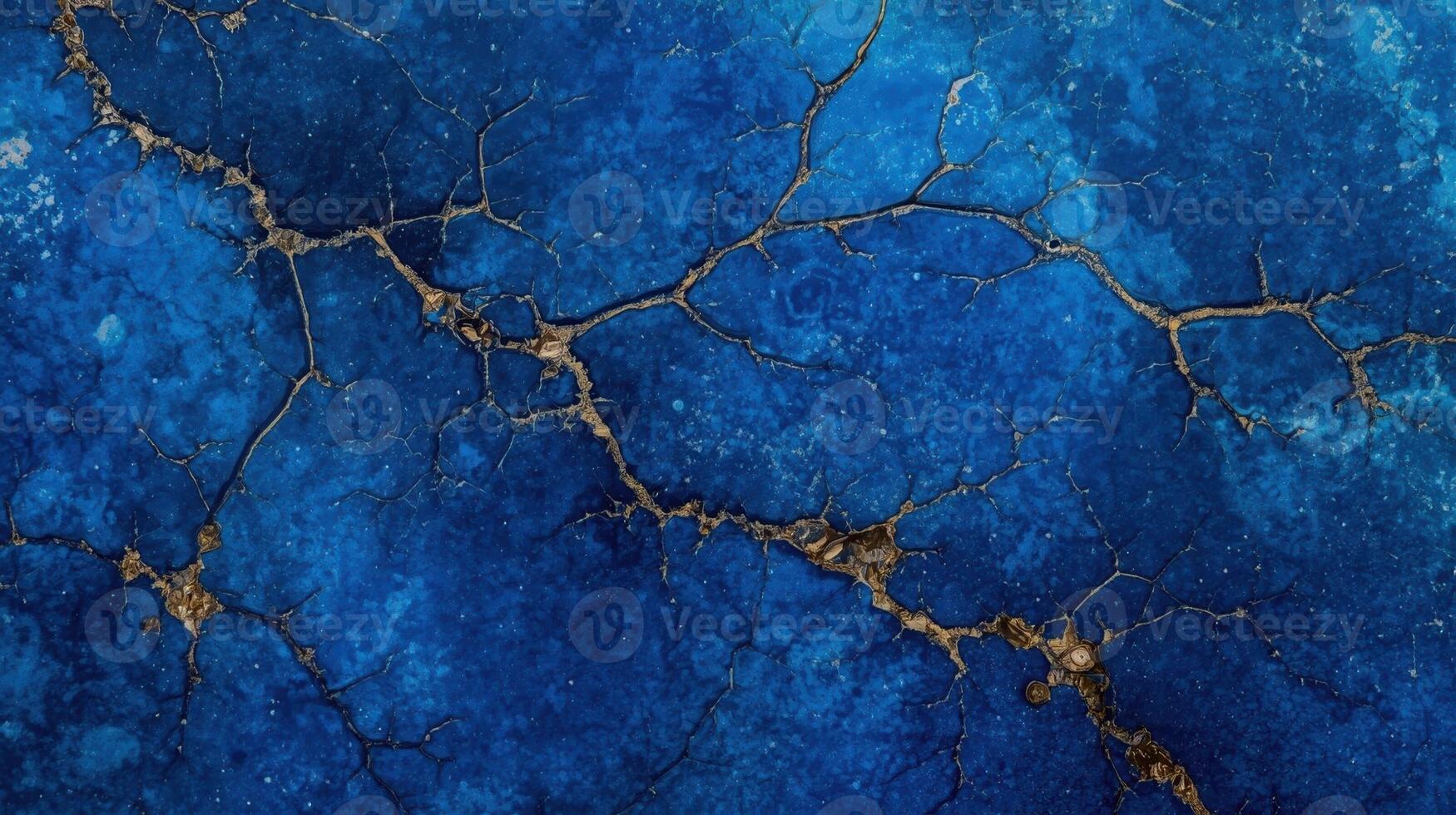 An abstract background showcases a textured surface of mottled blue with delicate gold cracks running across it, creating a beautiful pattern. photo