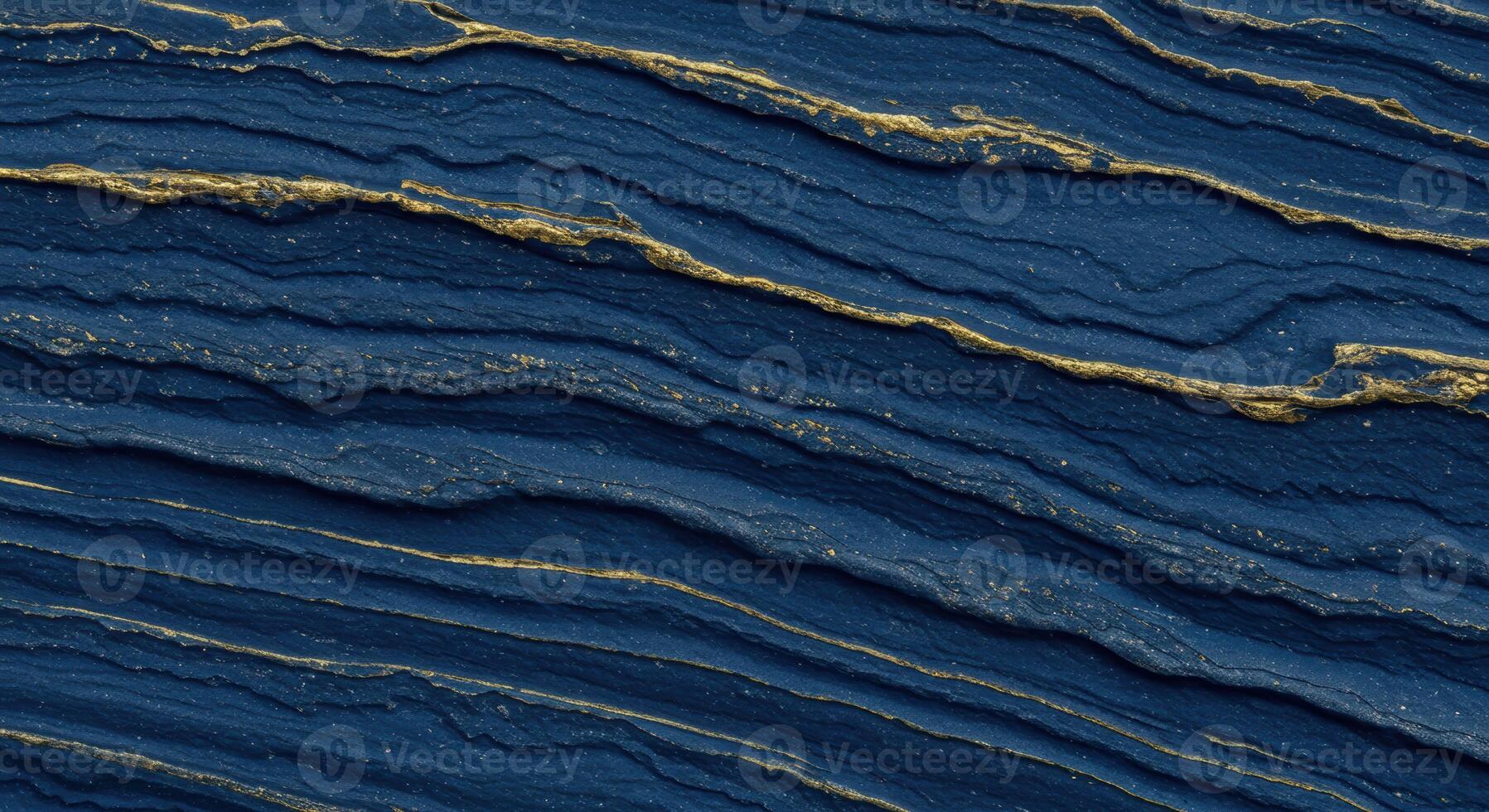 An abstract navy blue texture displays simulated rock strata interspersed with shimme gold veins to create a luxurious backdrop design. photo