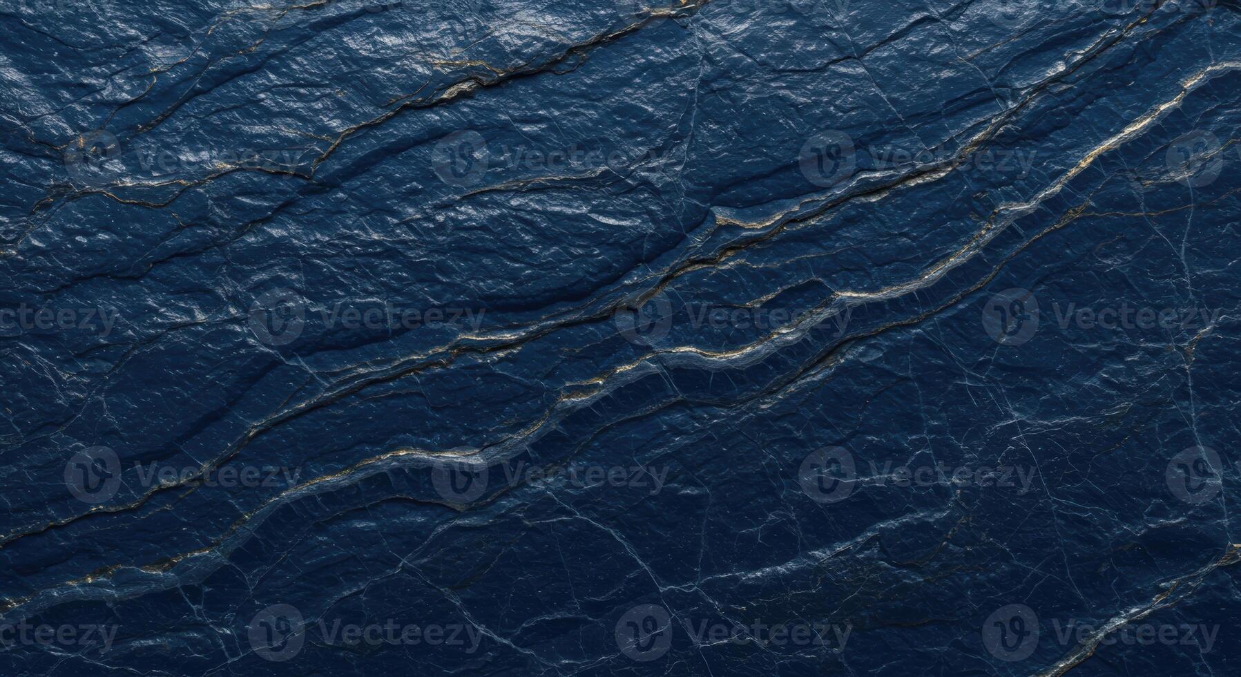 Abstract close up of dark blue textured rock surface with mineral veins creating a unique organic pattern on the natural stone background. photo