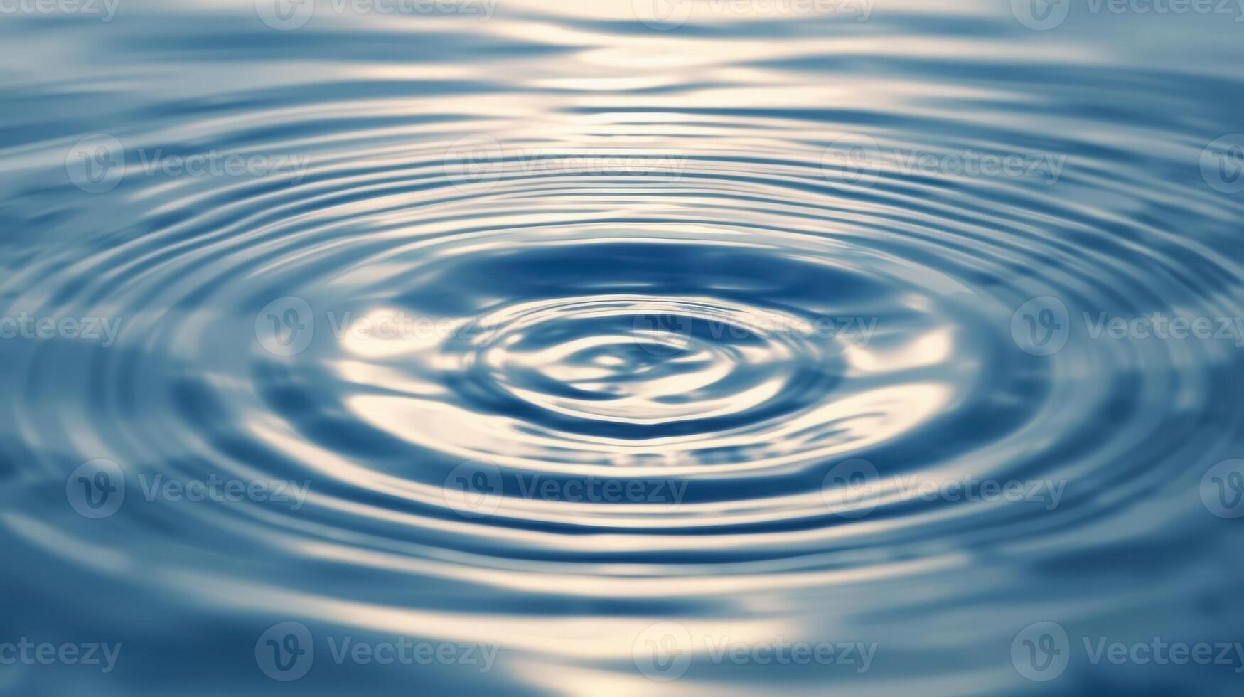 The gentle concentric ripples expand outwards after a small object drops into the tranquil blue water surface creating mesmerizing patterns. photo
