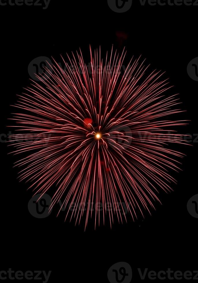 Burst of Red Fireworks Exploding in the Night Sky a Celebration of Light and Color Capturing the Magic of a Festive Event photo