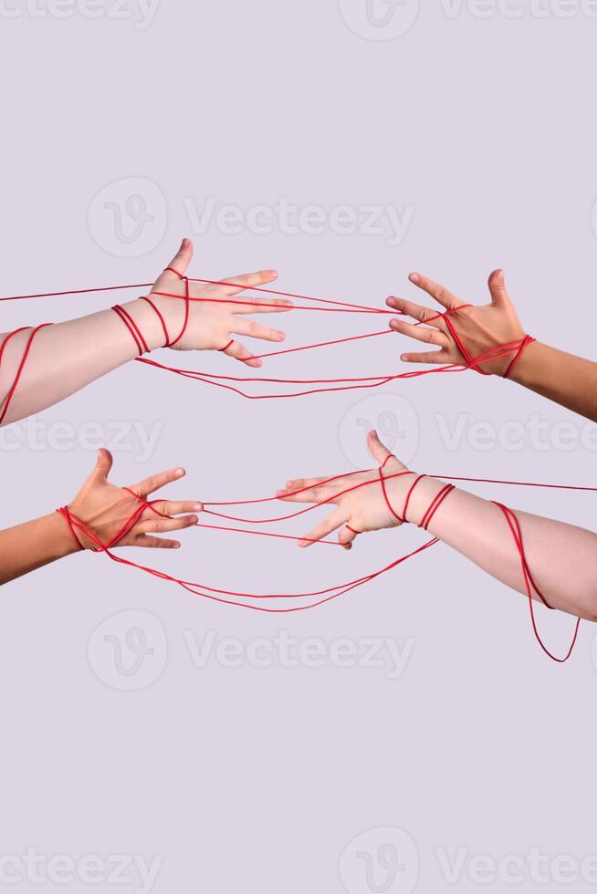 Hands with red string creating interconnected relationship concept photo