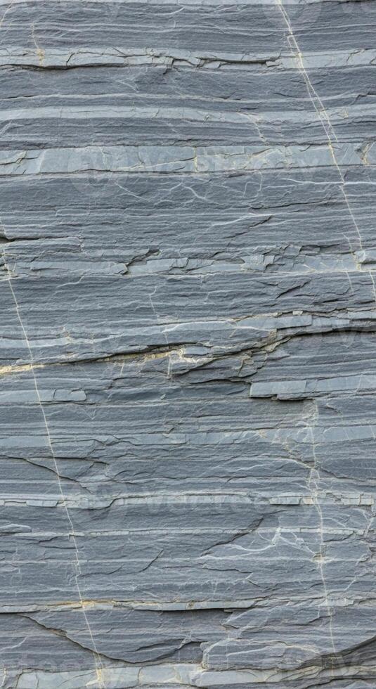 Close up abstract view of layered gray paper or cardboard with subtle horizontal lines and texture photo