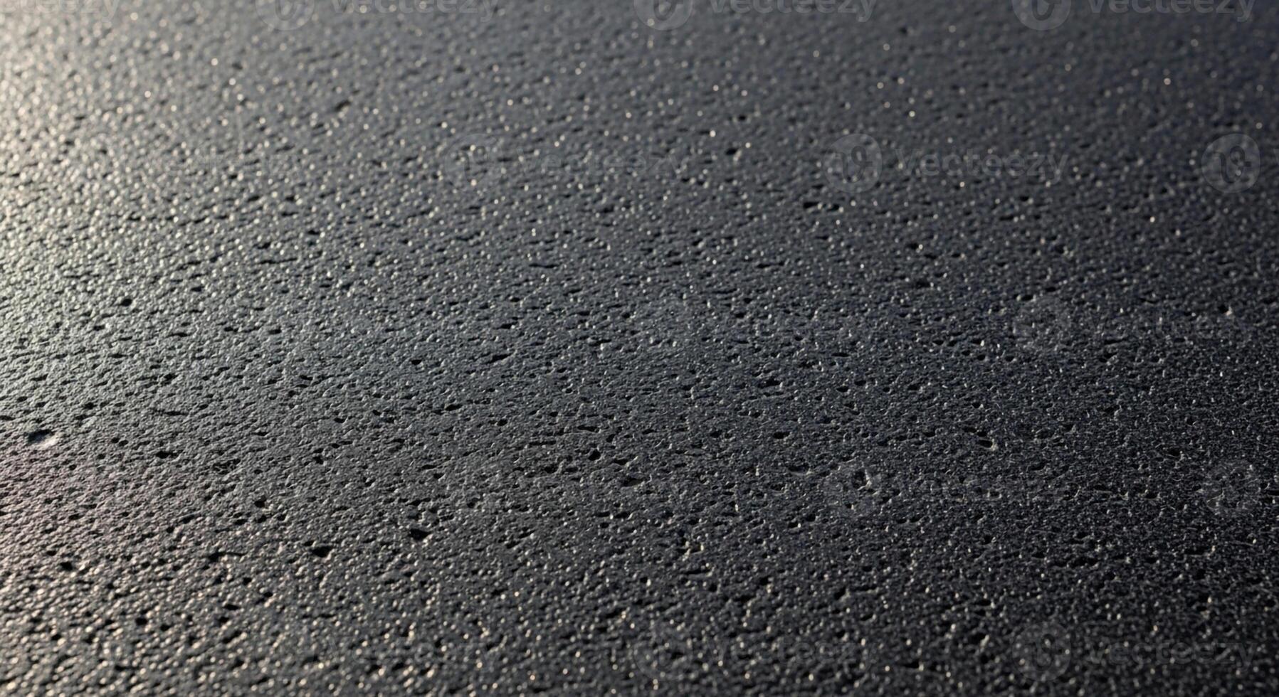 Close up textured surface with subtle light reflections and dark speckles creating a detailed abstract pattern photo