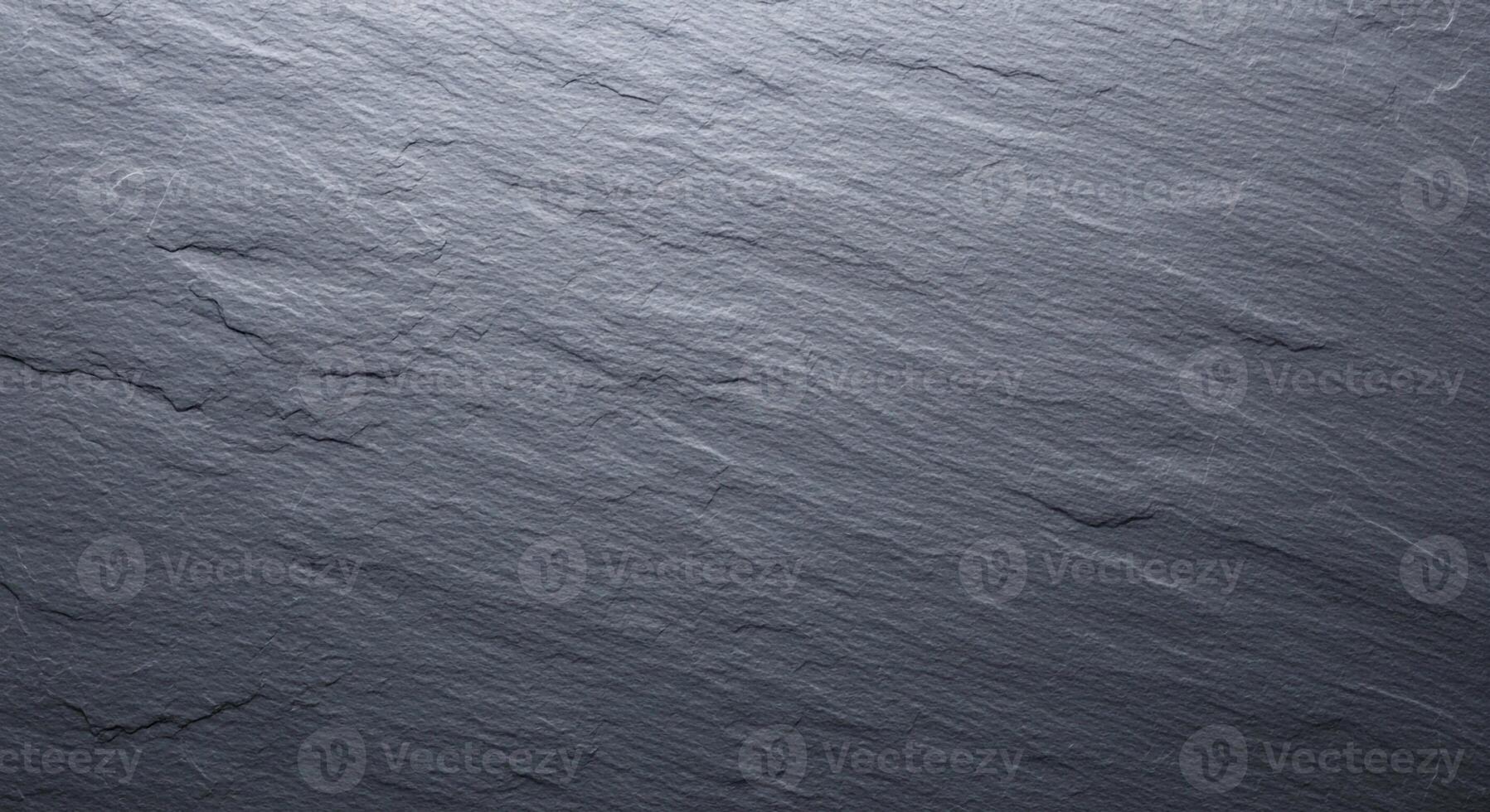 Close up textured background of natural dark grey slate stone with subtle linear patterns and variations photo