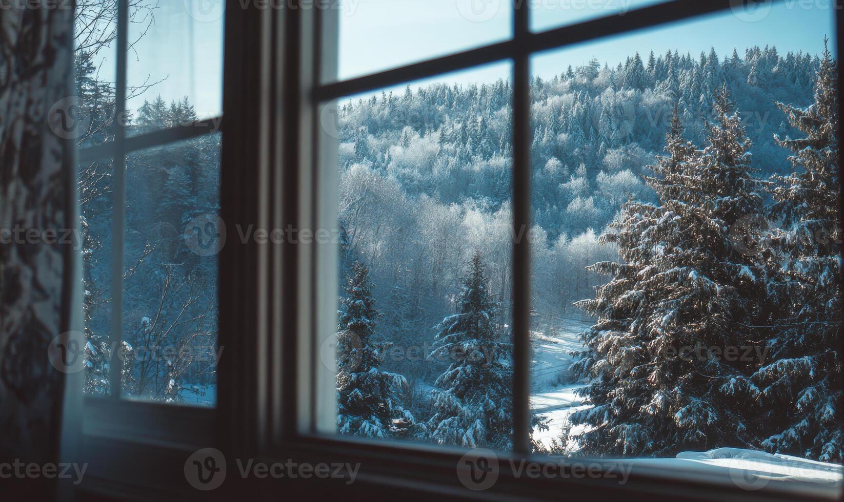 A window view of a snowy forest with trees and a river photo