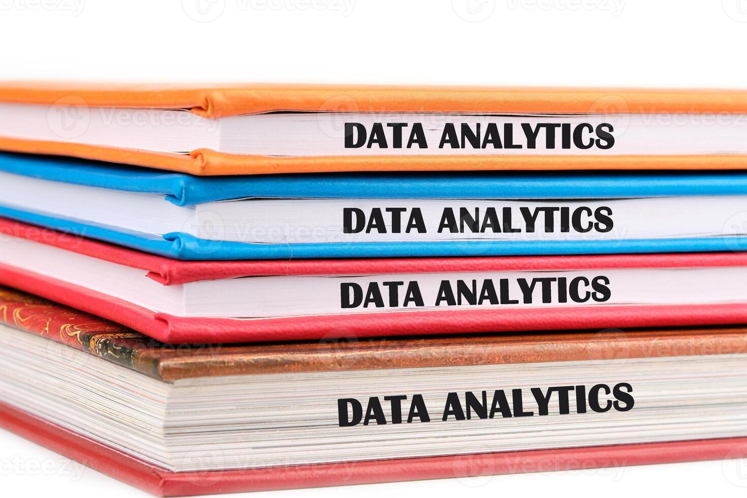 The concept of technology and development. Phrase, words, text DATA ANALYTICS on the ends of the notebooks assembled in a stack photo