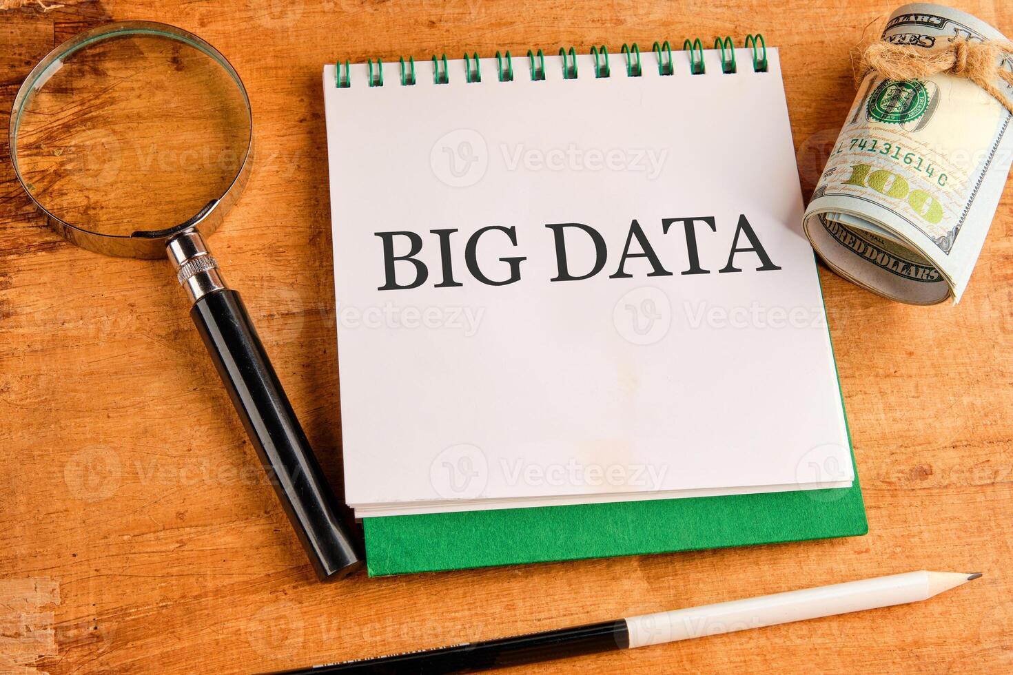 The concept of technology and development. Phrase, words, text BIG DATA in a notebook on an old background, top view photo