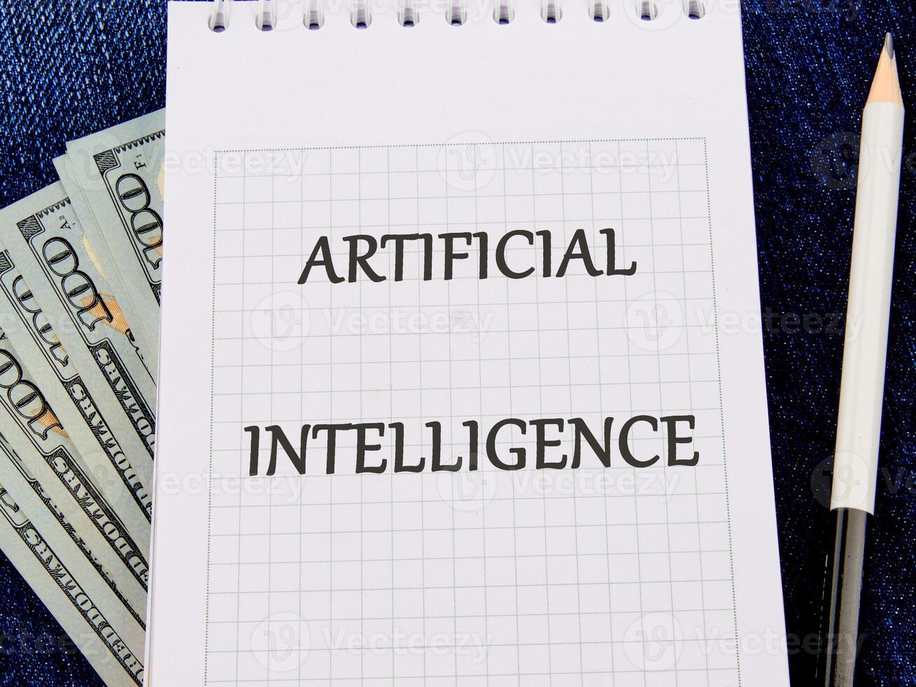 The concept of technology and development. Phrase, word, text ARTIFICIAL INTELLIGENCE on a blank sheet of notepad photo