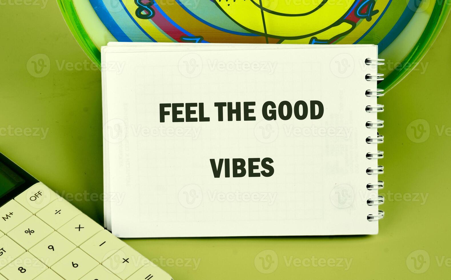 A workspace brimming with positivity features a notebook displaying an uplifting phrase. The cheerful atmosphere encourages creativity and good vibes during productive hours photo