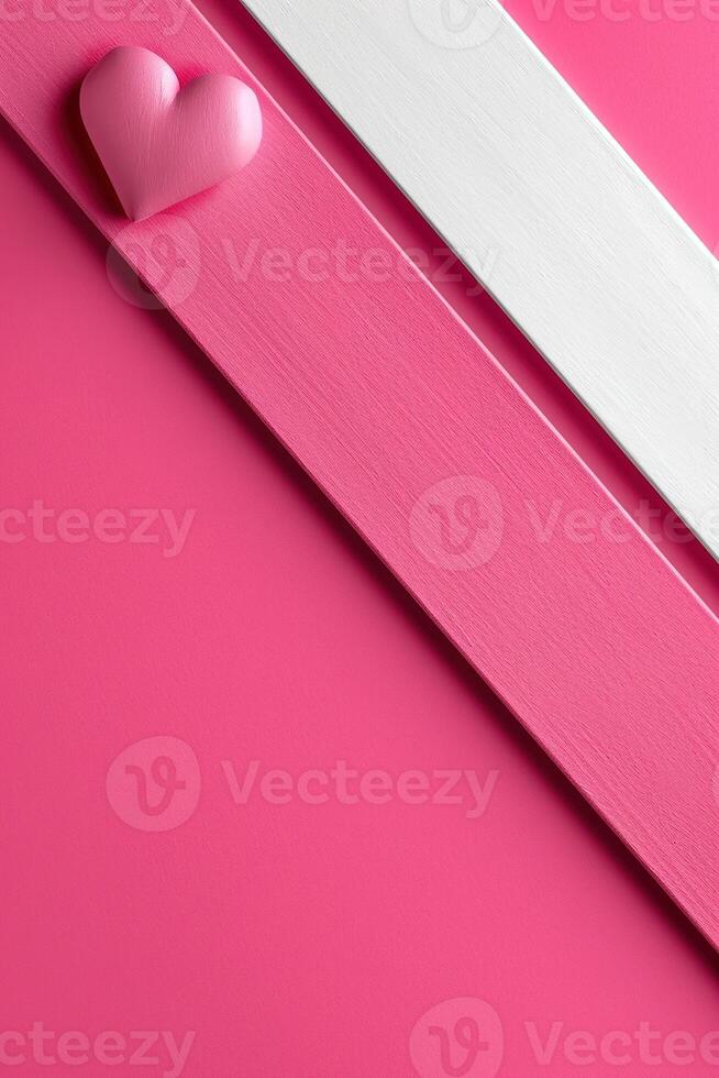 A charming heart in soft pink rests on a bright magenta backdrop. A bold white diagonal stripe adds contrast, creating a playful and lively mood for decoration photo