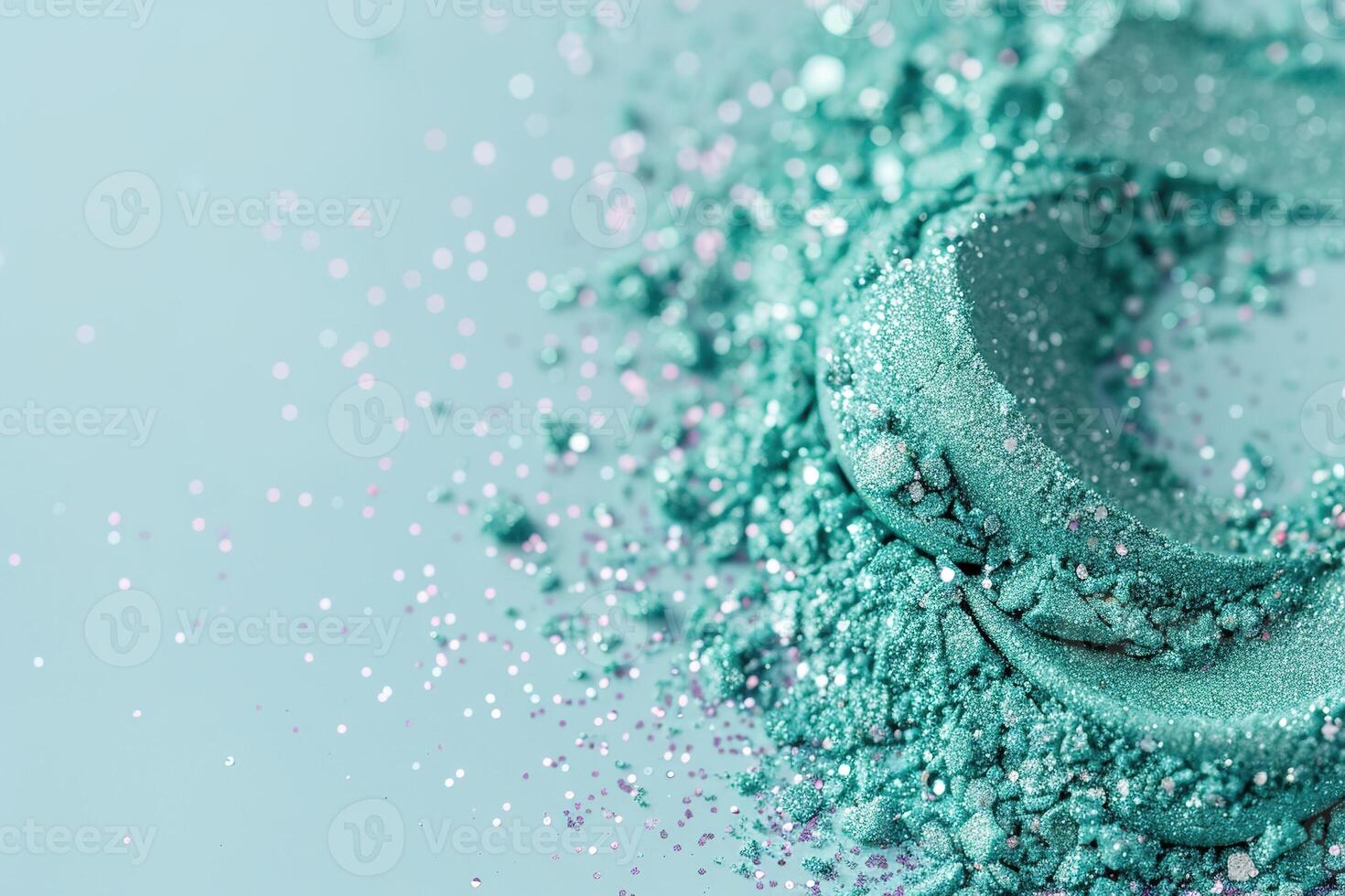 Teal glitter dust swirls in a soft gradient on a light blue background, showcasing a beautiful shimmer. The sparkling particles create an enchanting and vibrant look photo