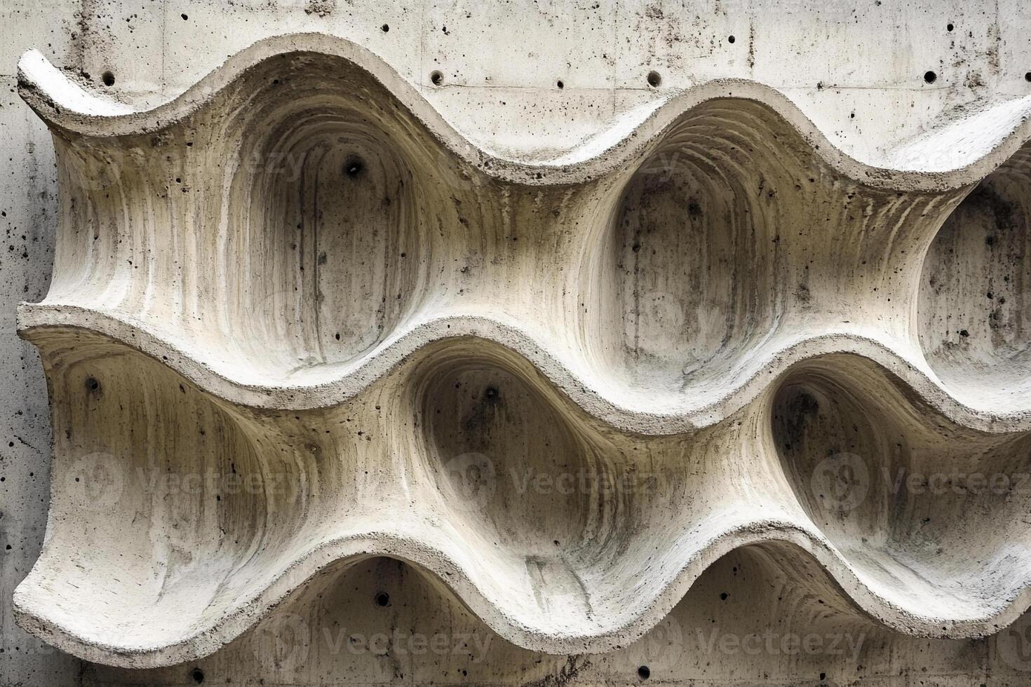 Unique concrete wall design showcasing undulating wave patterns during daylight photo