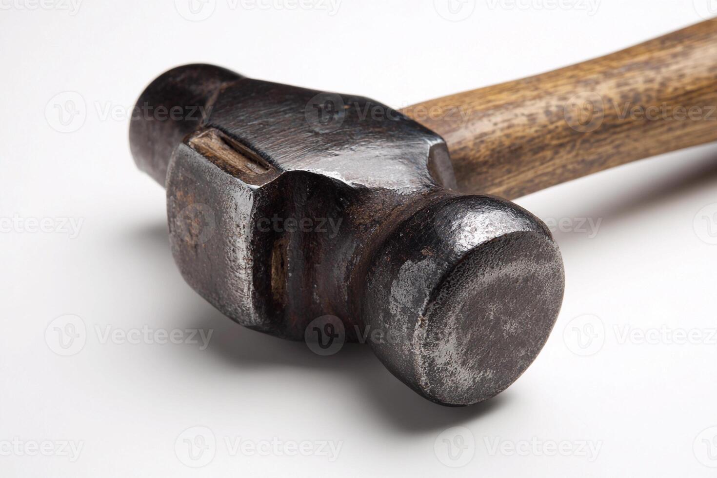 Hammer resting on a plain white background in a studio setting photo