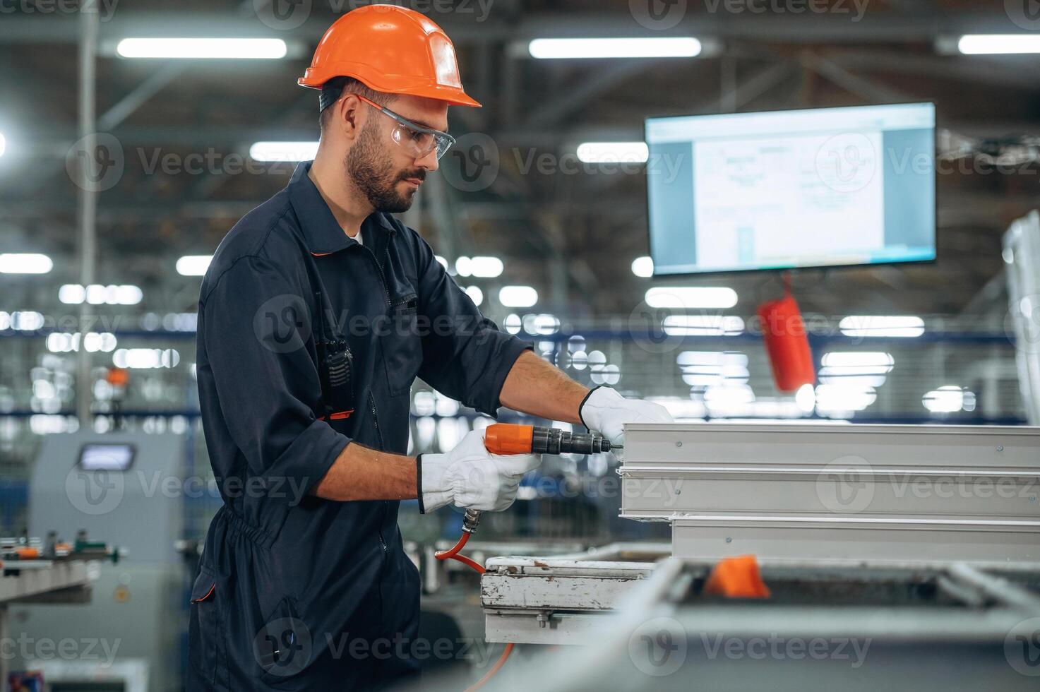 Worker with power tools in factory photo