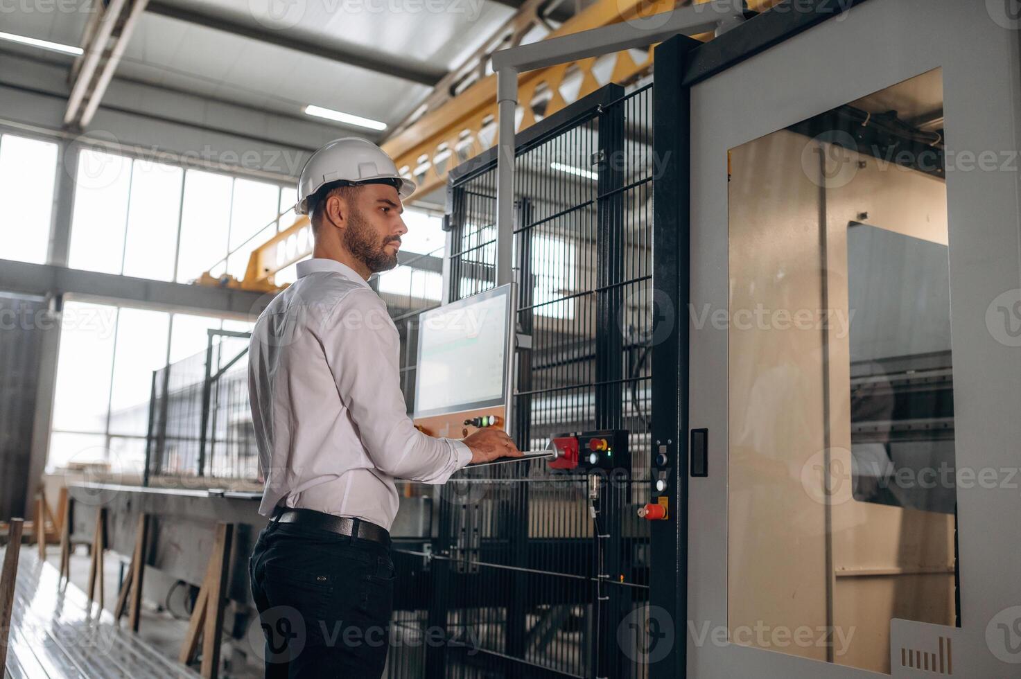 Operator at industrial machine controls photo