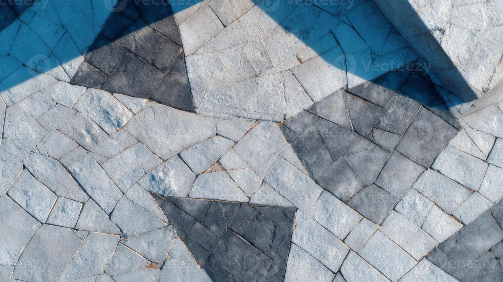 Aerial view of a geometric stone pavement with varying shades of gray and white, creating an abstract and artistic pattern. photo