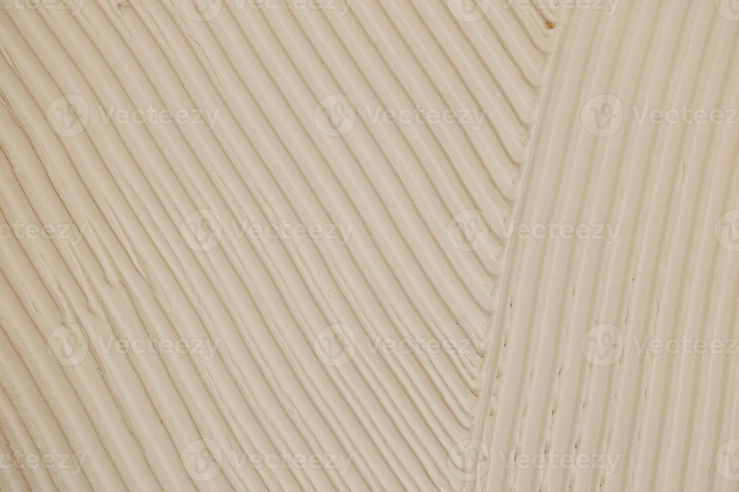 Textured surface shows smooth lines in off white color creating an artistic effect photo