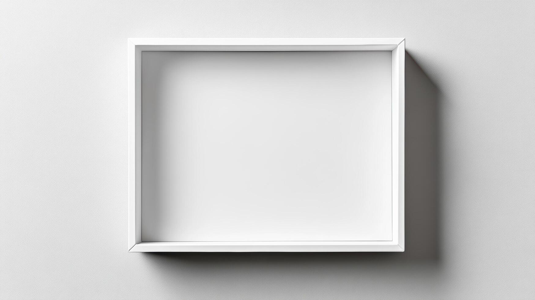 Empty white frame on a wall with a shadow photo