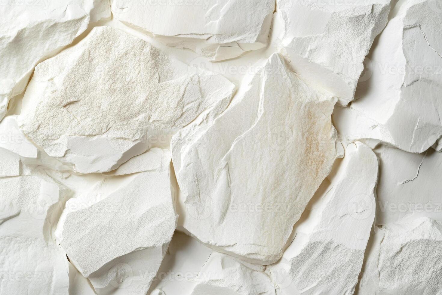 White textured stone wall featuring smooth, uneven surfaces and natural patterns, creating a visually appealing backdrop with copy space for design purposes photo