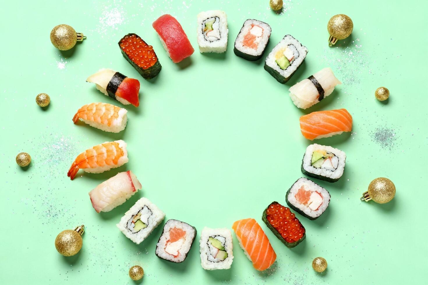 Colorful sushi assortment arranged in a circular pattern on a mint green background, surrounded by festive golden ornaments, creating a vibrant and appetizing visual display photo