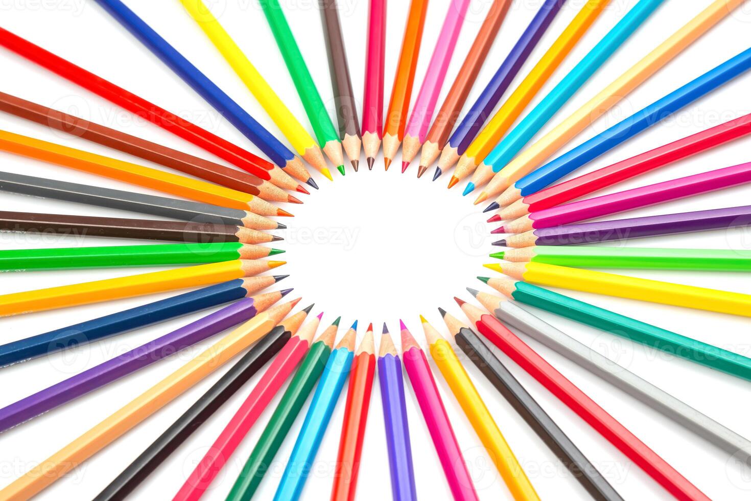 the a Multicolored pencils arranged in a circular pattern against a white backdrop, forming a central frame. Ideal for artistic projects, school supplies, or creative design concepts. photo