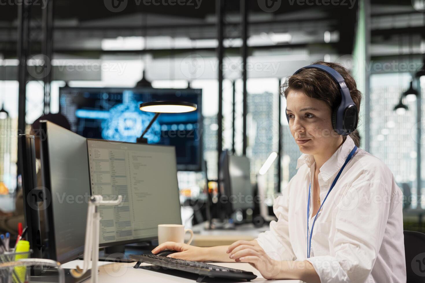Computer scientist listening music in startup company office, testing AI deep learning algorithms. IT specialist wearing headphones scaling productivity with artificial intelligence tech on PC photo
