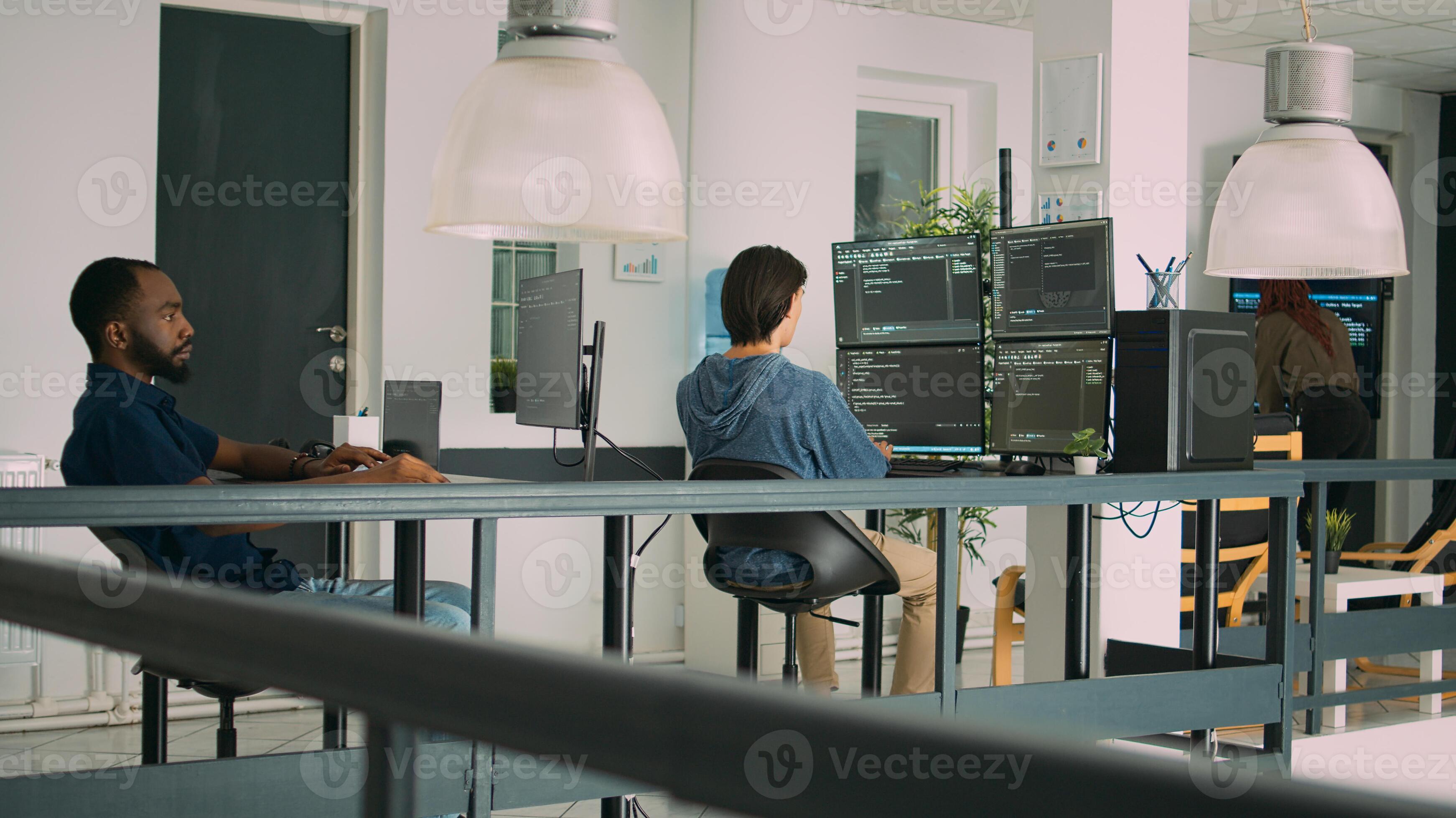 smiling software developer programming server code... Diverse artificial intelligence programers typing system code and ...