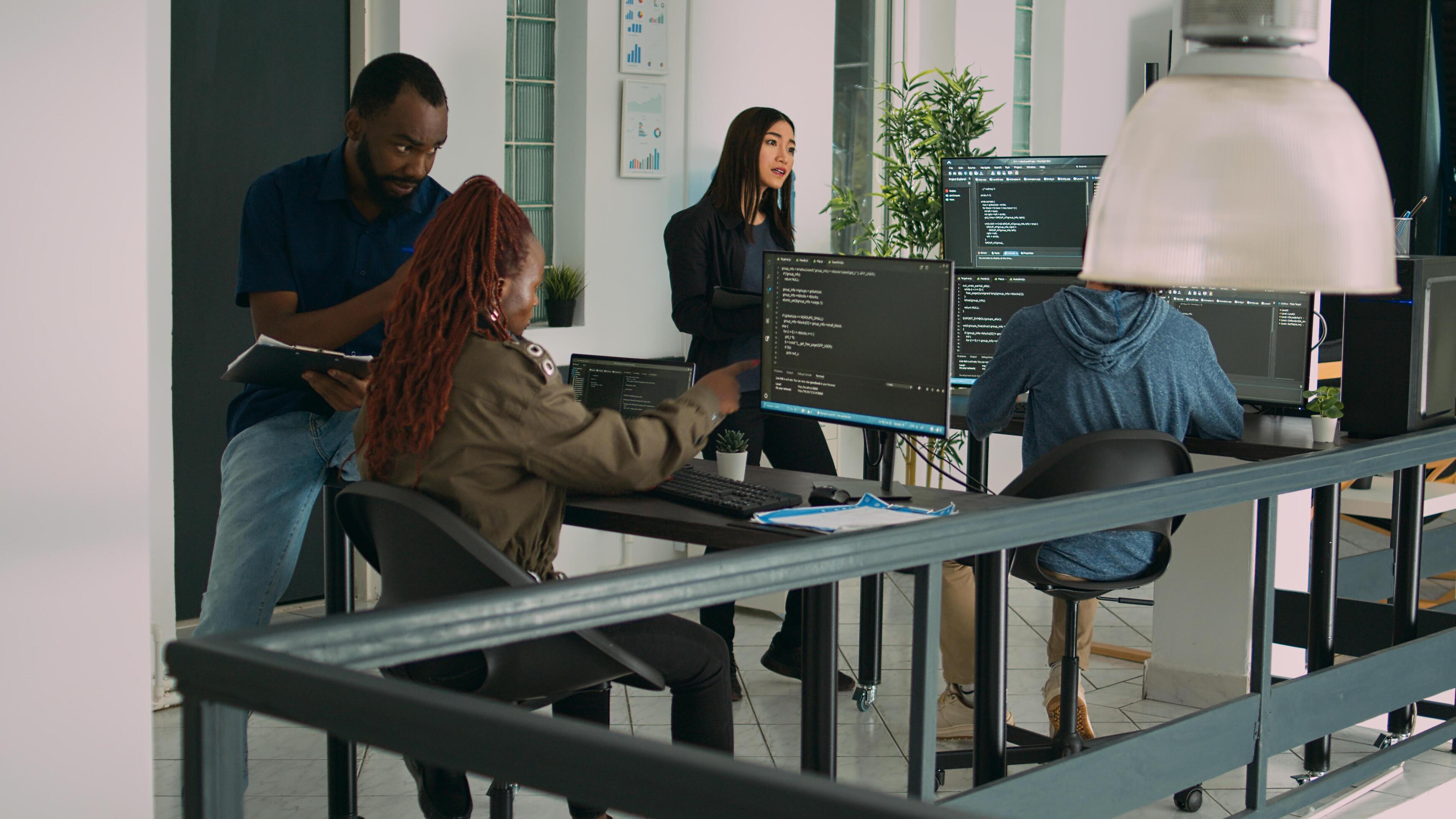 Junior developer working on terminal window to code system script, using multiple monitors with source code database. Programer writing algorithm with it html language, cloud computing. photo