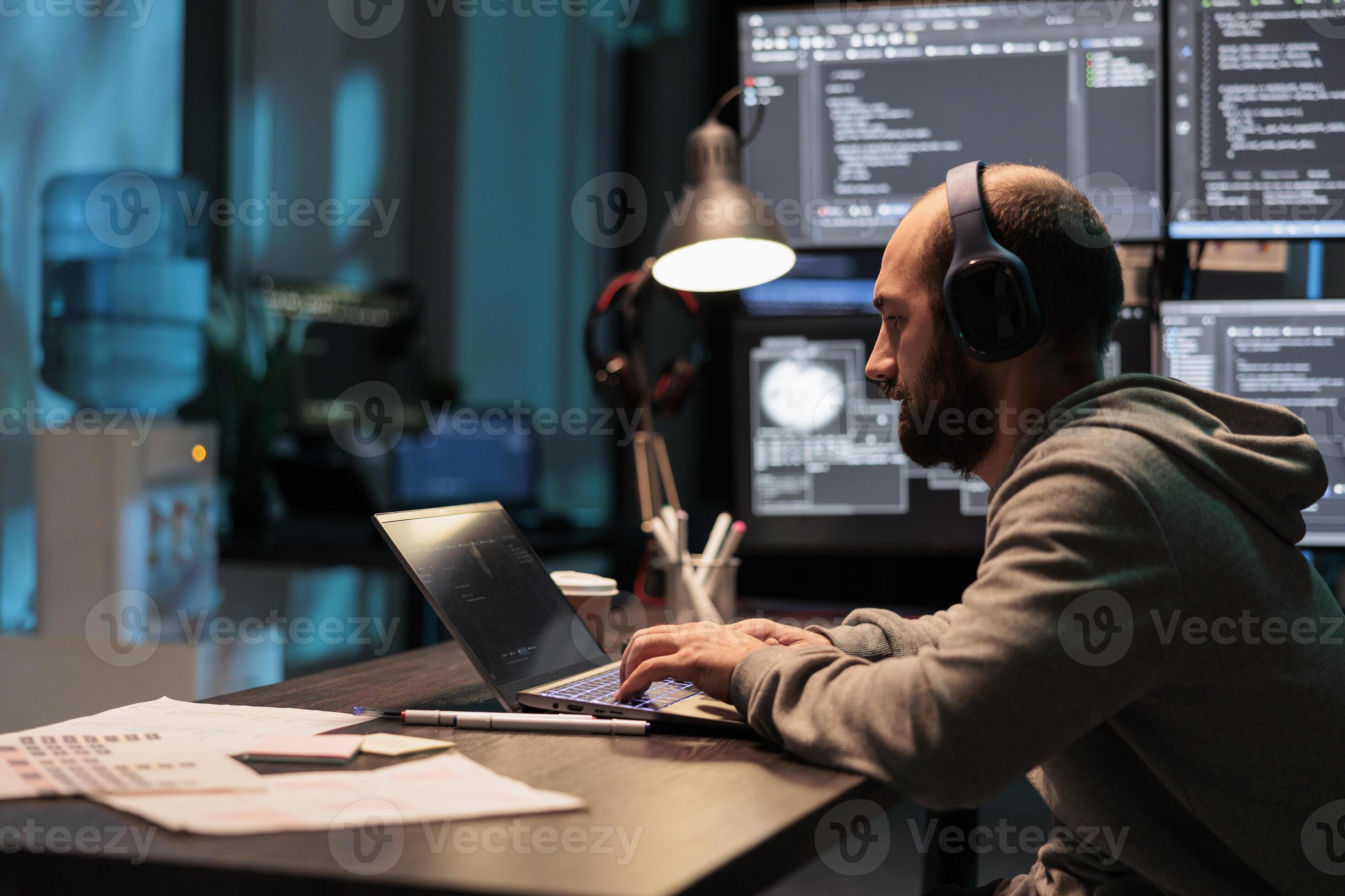 System engineer programming user interface on computer and compiling ...
