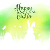 Easter background with silhouette of bunny in grass on a waterco vector