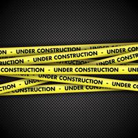 Under construction on tape on metal background vector