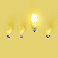 Energy saver lightbulb among old ones, vector illustration