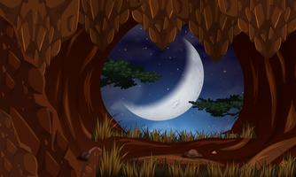 Cave at night with moon scene vector