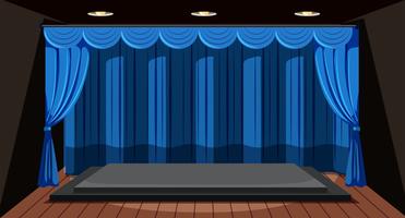 Un escenario vacío con cortina azul.