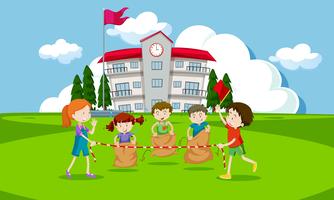 Young children having a potato sack race vector